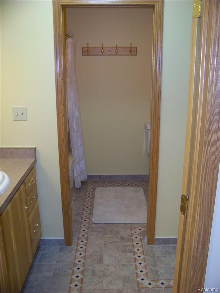9967 Chinavare Road Newport, MI 48166 - Photo 41 of 45 Custom porcelain tile in the upper level full bathroom.