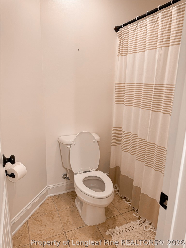93 Falcon Ridge Drive Spring Lake, NC 28390 - Photo 36 of 50 a white toilet sitting next to a shower curtain