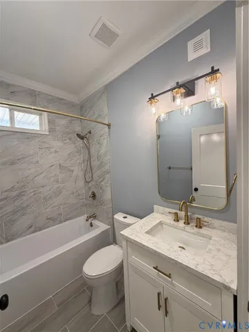 a living room with a couch and a chandelier