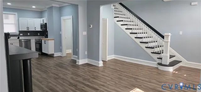 a kitchen with stainless steel appliances kitchen island granite countertop a refrigerator and a stove top oven