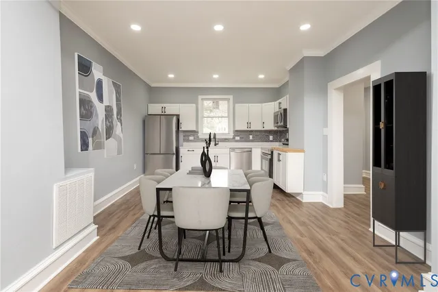 a kitchen with a refrigerator and white cabinets