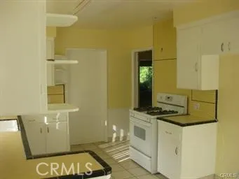 a room with a stove and a wooden floor