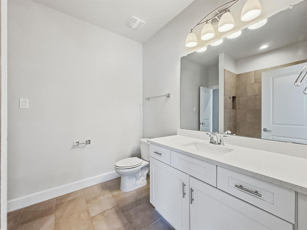 5704 Woodlands Drive The Colony, TX 75056 - Photo 14 of 23 a bathroom with a sink a toilet and a mirror