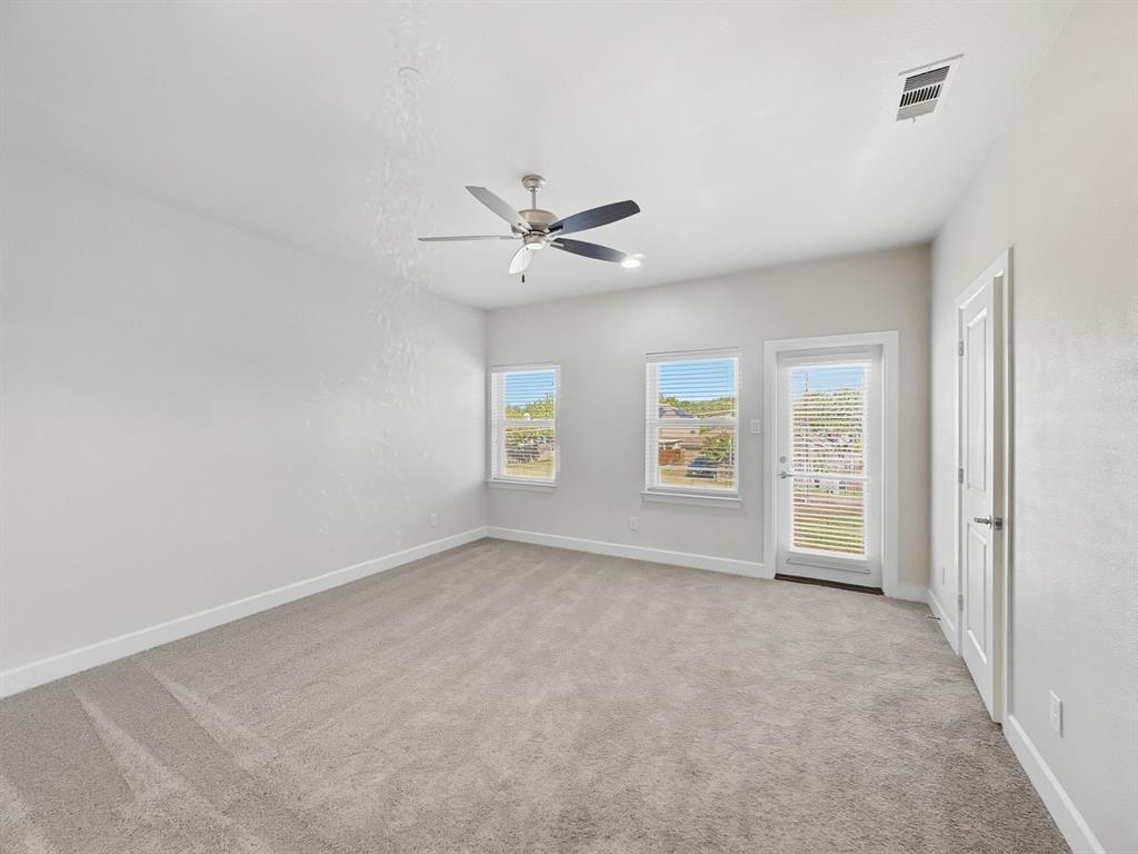 5704 Woodlands Drive The Colony, TX 75056 - Photo 16 of 23 an empty room with windows and fan