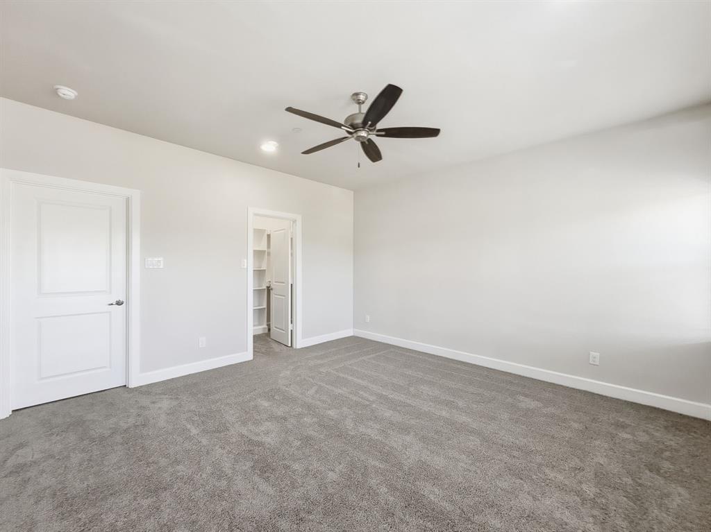 5704 Woodlands Drive The Colony, TX 75056 - Photo 17 of 23 an empty room with closet and windows