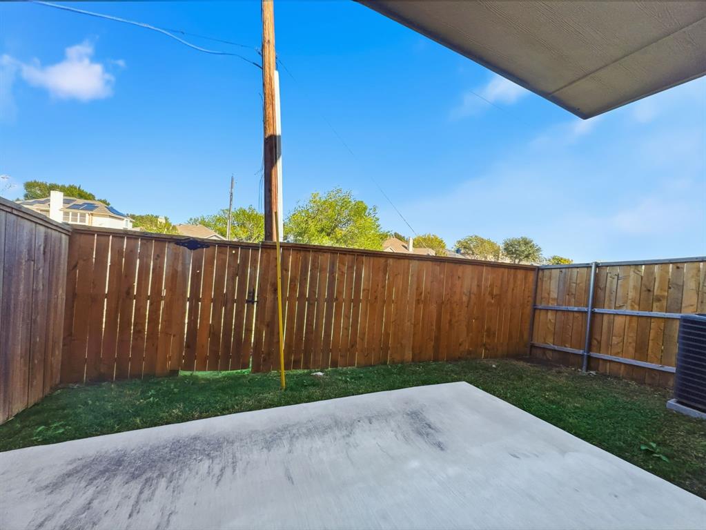 5704 Woodlands Drive The Colony, TX 75056 - Photo 21 of 23 a view of a backyard with wooden fence