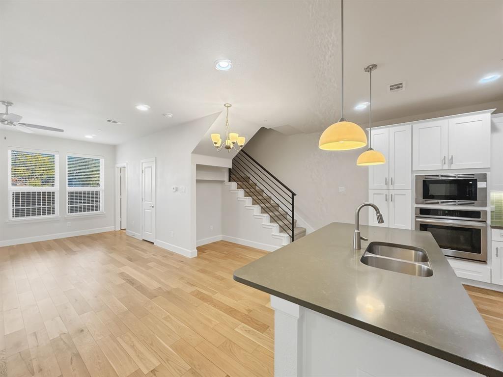 5704 Woodlands Drive The Colony, TX 75056 - Photo 22 of 23 a kitchen with stainless steel appliances a sink a stove and a refrigerator