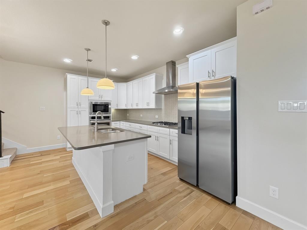 5704 Woodlands Drive The Colony, TX 75056 - Photo 4 of 23 a kitchen with stainless steel appliances granite countertop a refrigerator a sink and a stove
