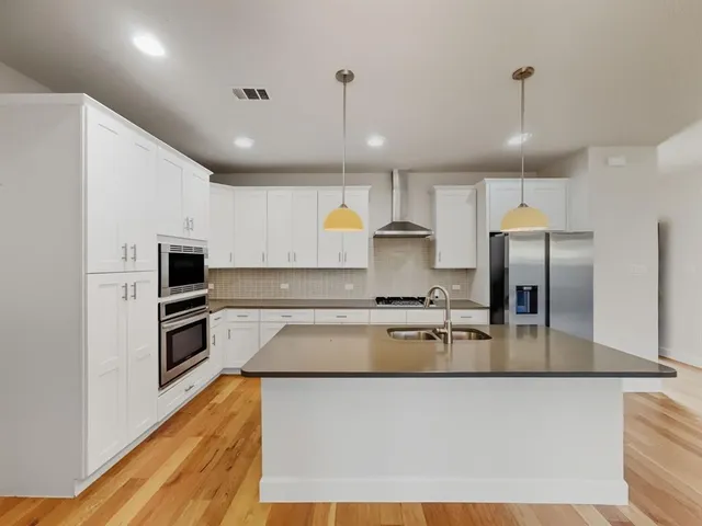 a view of a kitchen with a sink and a stove