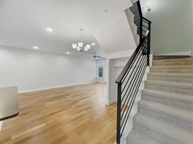 a kitchen with stainless steel appliances granite countertop a refrigerator a sink and a stove