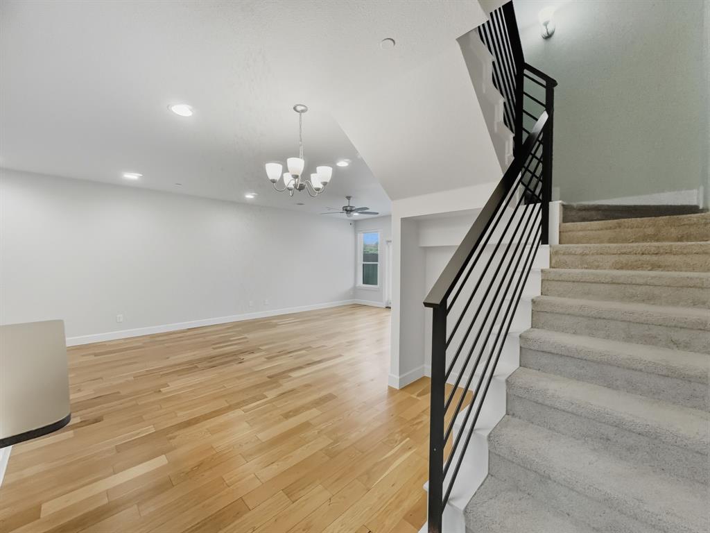 5704 Woodlands Drive The Colony, TX 75056 - Photo 6 of 23 wooden floor in an empty room with stairs