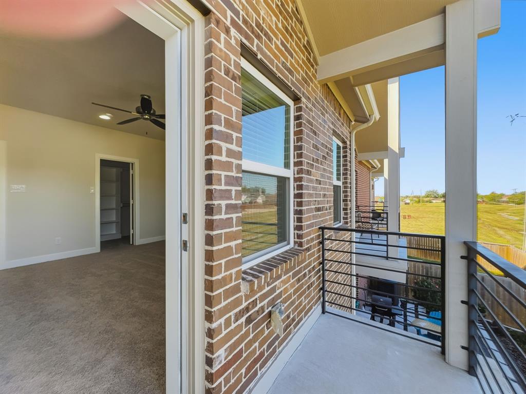 5704 Woodlands Drive The Colony, TX 75056 - Photo 8 of 23 a view of a balcony with a table and chairs