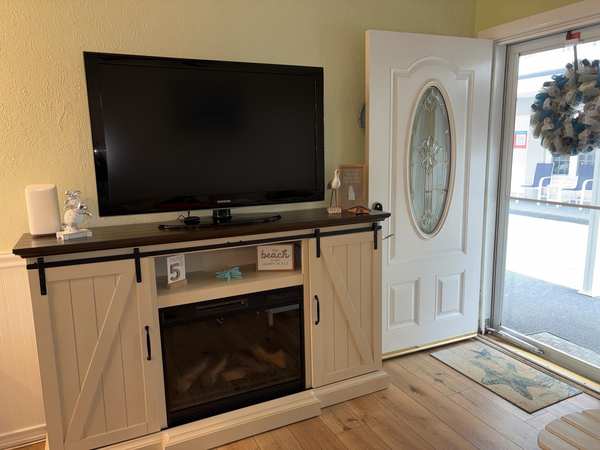 310 East Hand, Unit 4 Wildwood, NJ 08260 - Photo 6 of 17 a living room with a flat screen tv and a fireplace