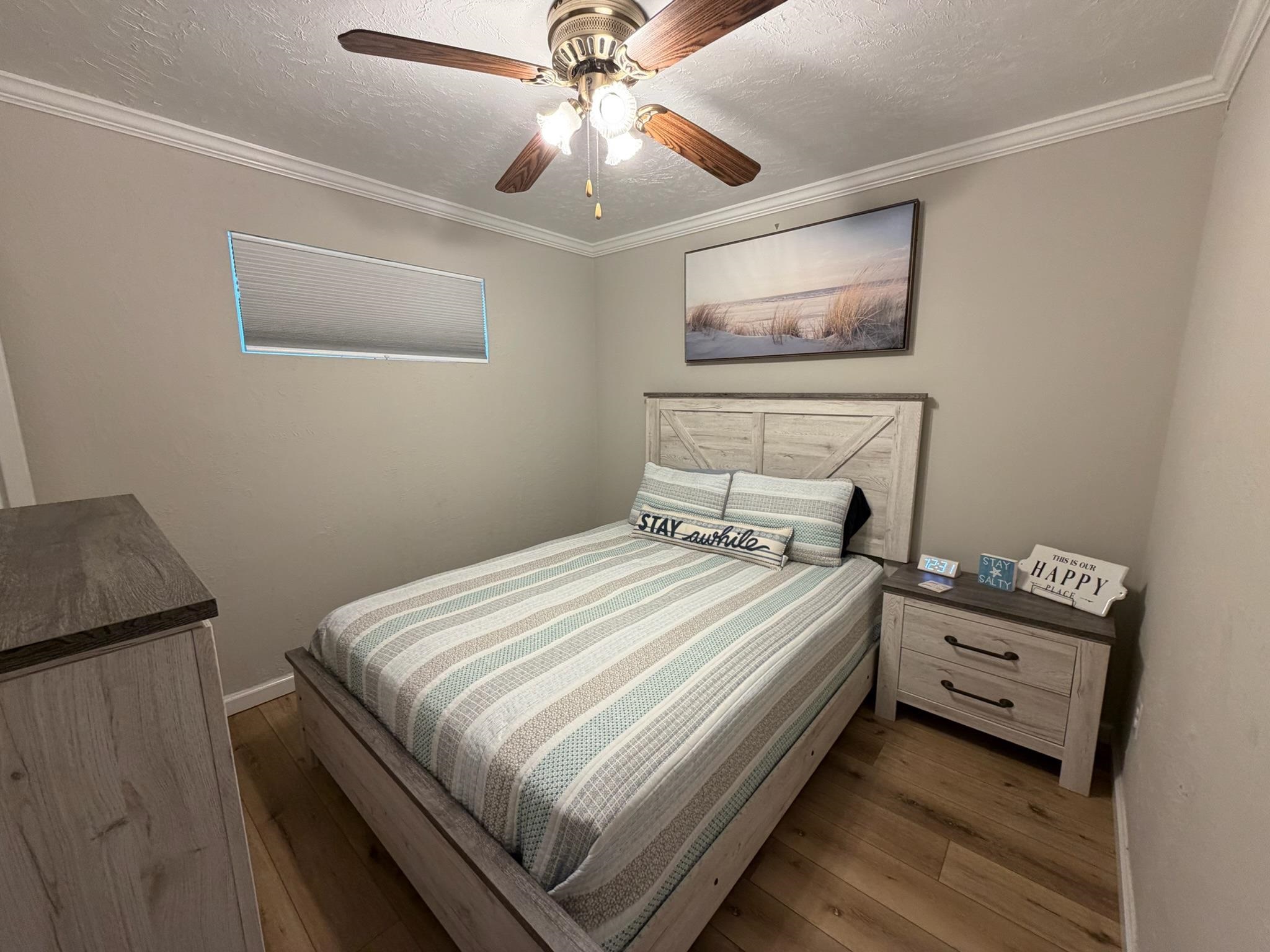 310 East Hand, Unit 4 Wildwood, NJ 08260 - Photo 8 of 17 a bedroom with bed and a chandelier