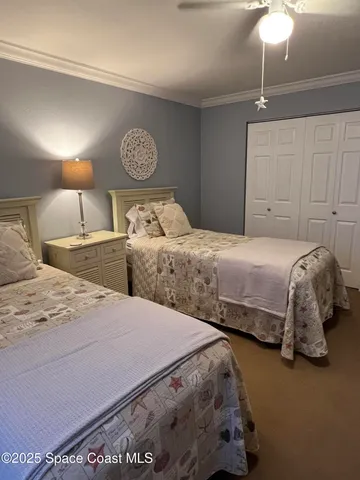 a bedroom with a bed and chandelier