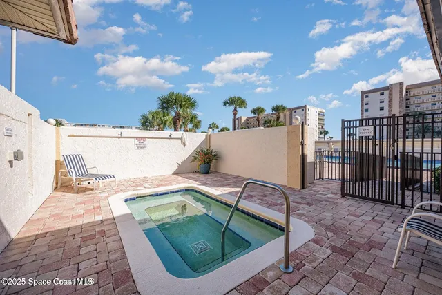 a view of a swimming pool with outdoor seating