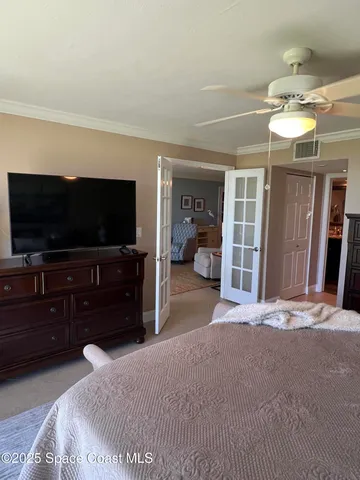 a bedroom with furniture and flat screen tv