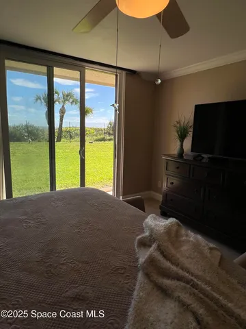 a bedroom with a bed and large window