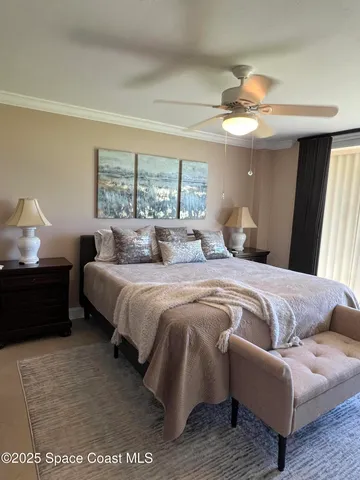 a bedroom with a bed couch and window