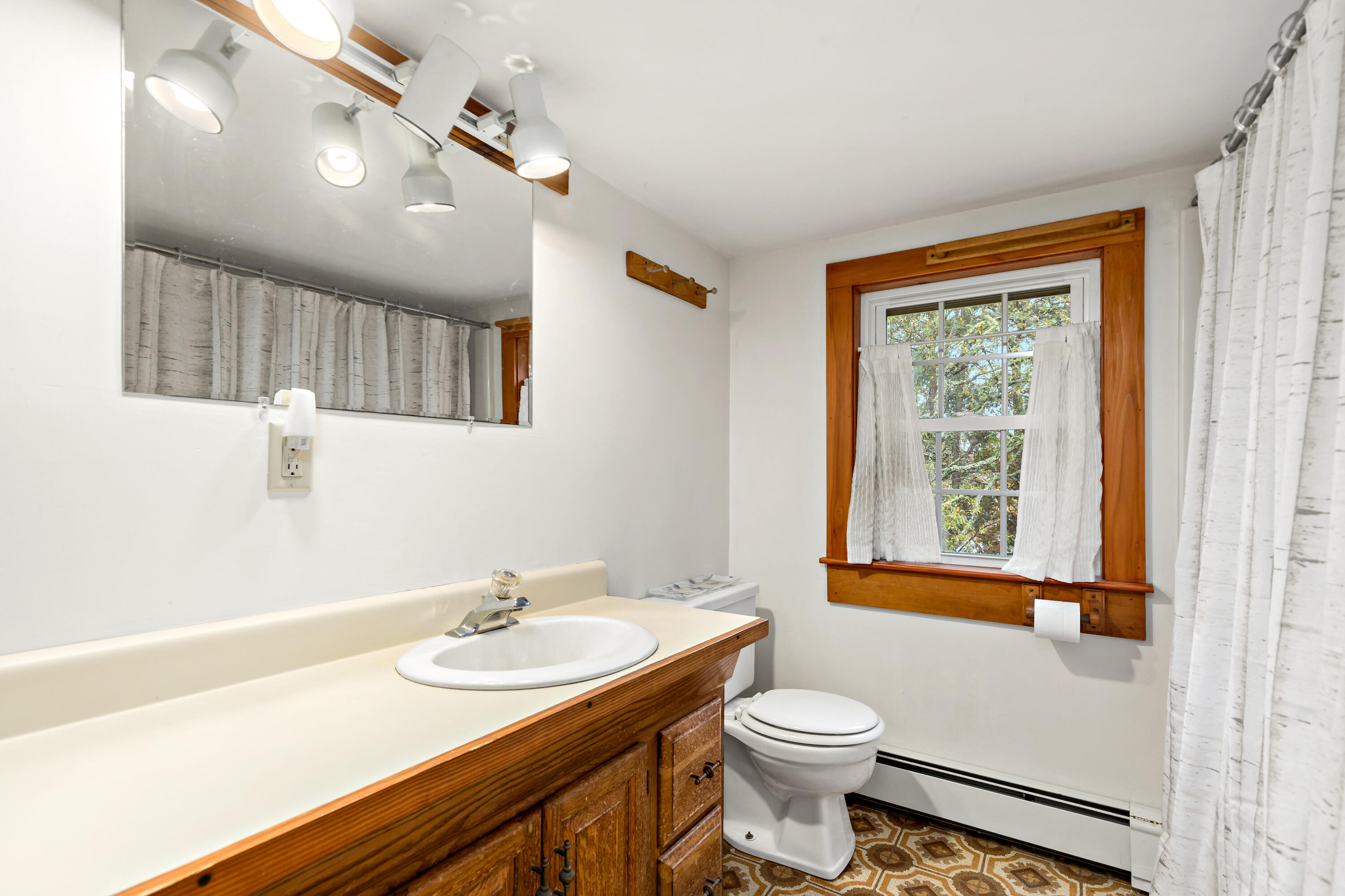 520 Samoset Road Eastham, MA 02642 - Photo 31 of 46 a bathroom with a sink a toilet a mirror and a tub