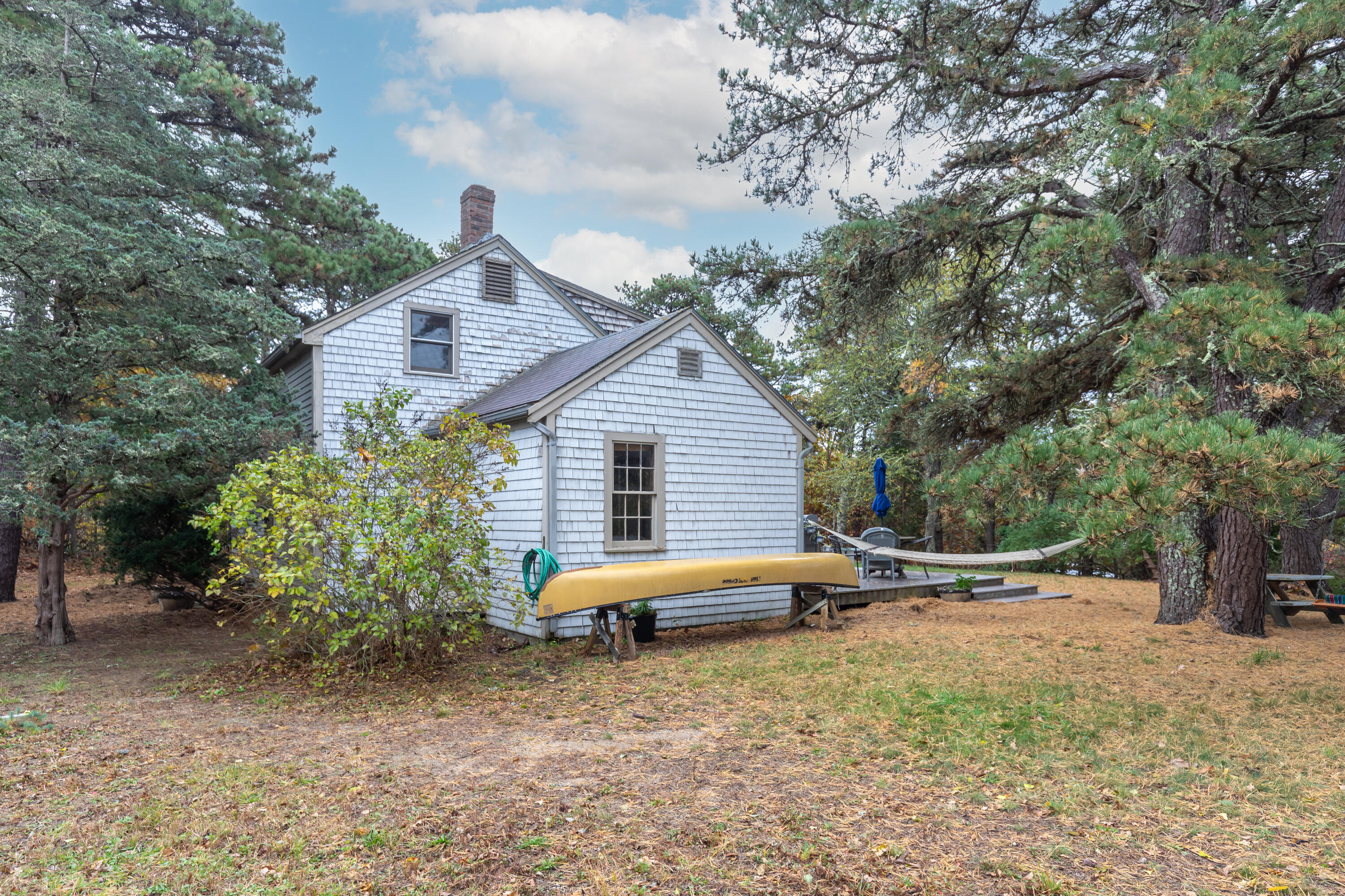 520 Samoset Road Eastham, MA 02642 - Photo 9 of 46 a backyard of a house with barbeque oven table and chairs