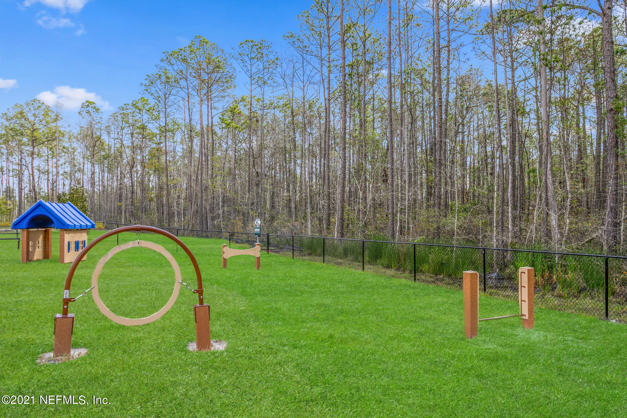 142 Dove Tree Ln Street St. Augustine, FL 32095 - Photo 31 of 47 a view of a park with large trees and a wooden fence