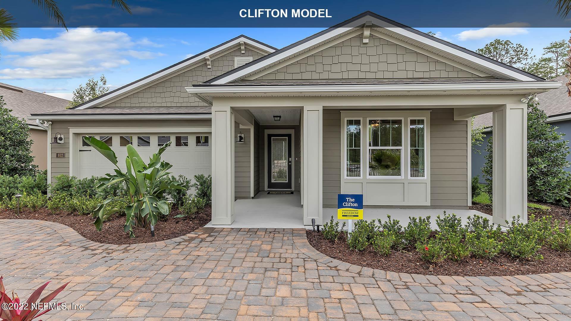 142 Dove Tree Ln Street St. Augustine, FL 32095 - Photo 3 of 47 a front view of a house with garden