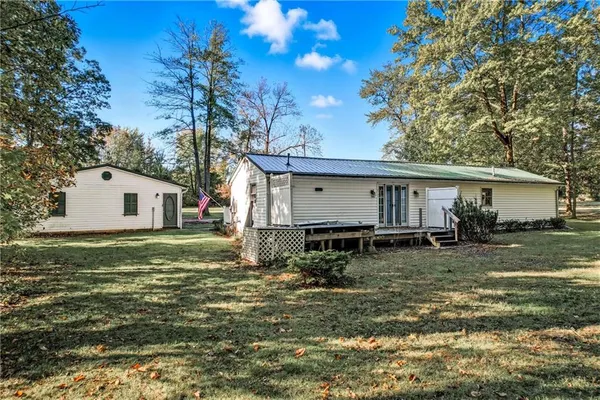 a view of backyard of house with green space