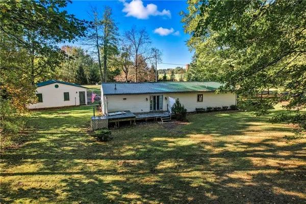 a view of a house with backyard porch and furniture