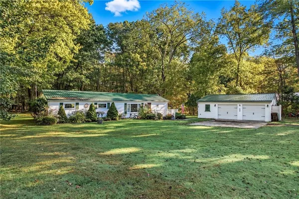 a front view of a house with a garden