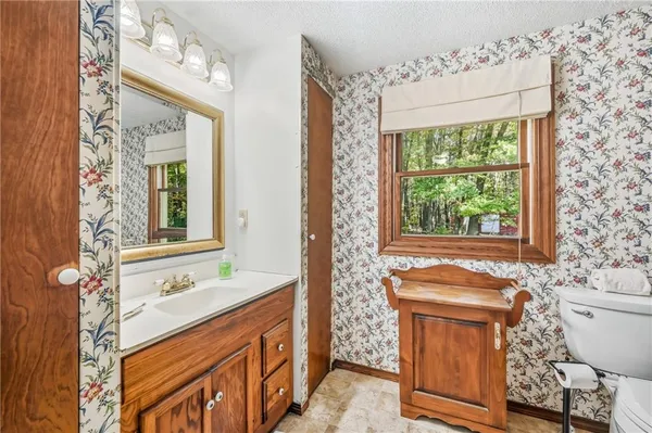 a view of empty room with cabinet and stairs