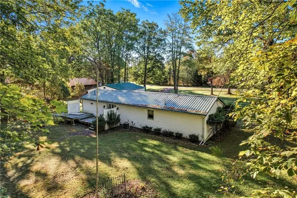a view of a house with a yard and sitting area