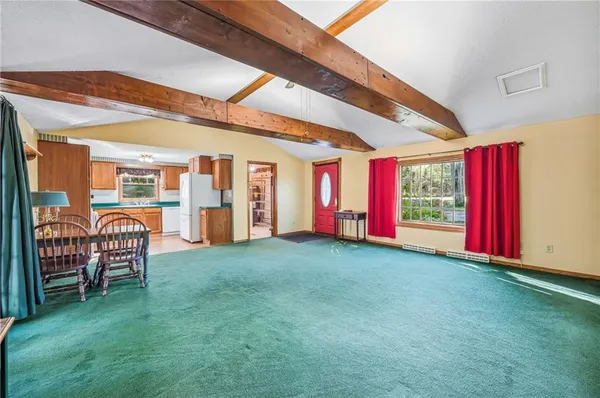 a kitchen with stainless steel appliances granite countertop a refrigerator a sink dishwasher a stove and white countertops with wooden floor