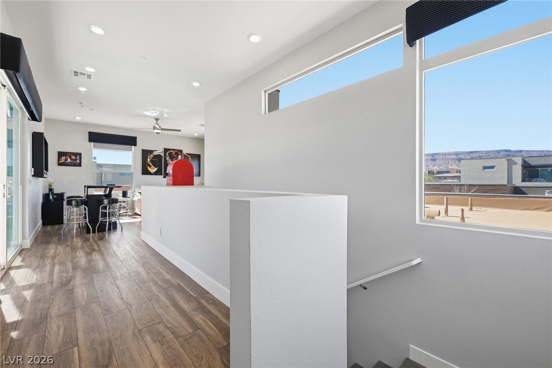 4246 Swift Street Las Vegas, NV 89135 - Photo 26 of 71 Hallway with dark wood-style floors, healthy amount of natural light, recessed lighting, and an upstairs landing