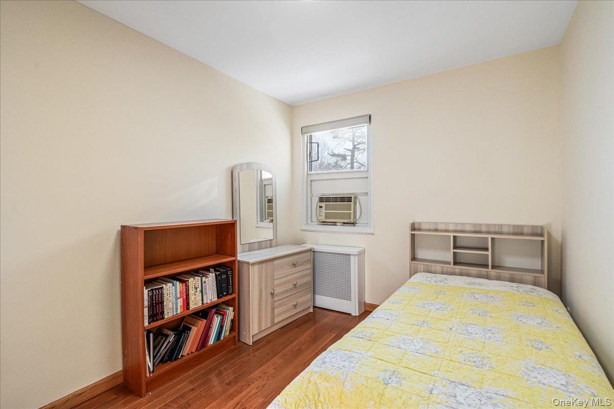 218-07 73rd Avenue, Unit UPPR Queens, NY 11364 - Photo 15 of 23 a bedroom with a bed and a book shelf