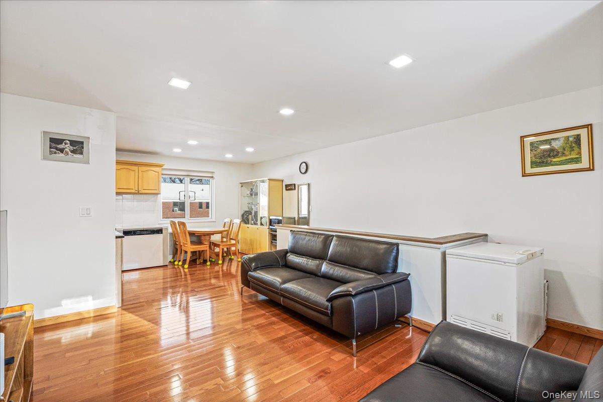 218-07 73rd Avenue, Unit UPPR Queens, NY 11364 - Photo 18 of 23 a living room with furniture and a wooden floor