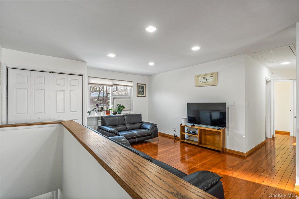 218-07 73rd Avenue, Unit UPPR Queens, NY 11364 - Photo 19 of 23 a living room with furniture flat screen tv and outdoor view