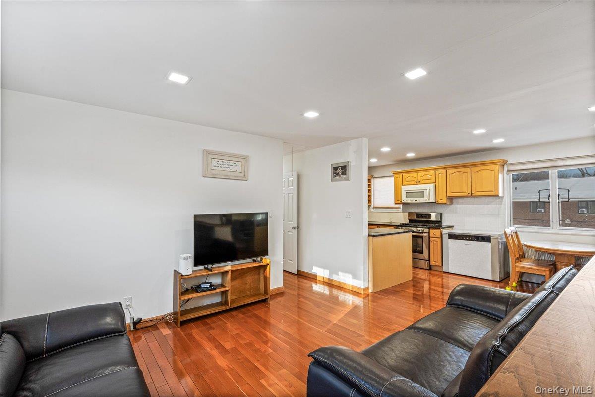 218-07 73rd Avenue, Unit UPPR Queens, NY 11364 - Photo 2 of 23 a living room with furniture and a flat screen tv