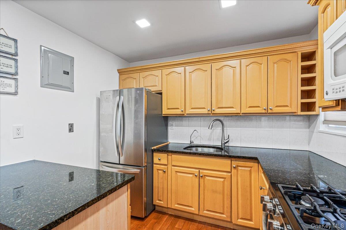 218-07 73rd Avenue, Unit UPPR Queens, NY 11364 - Photo 4 of 23 a kitchen with stainless steel appliances granite countertop a sink stove and refrigerator
