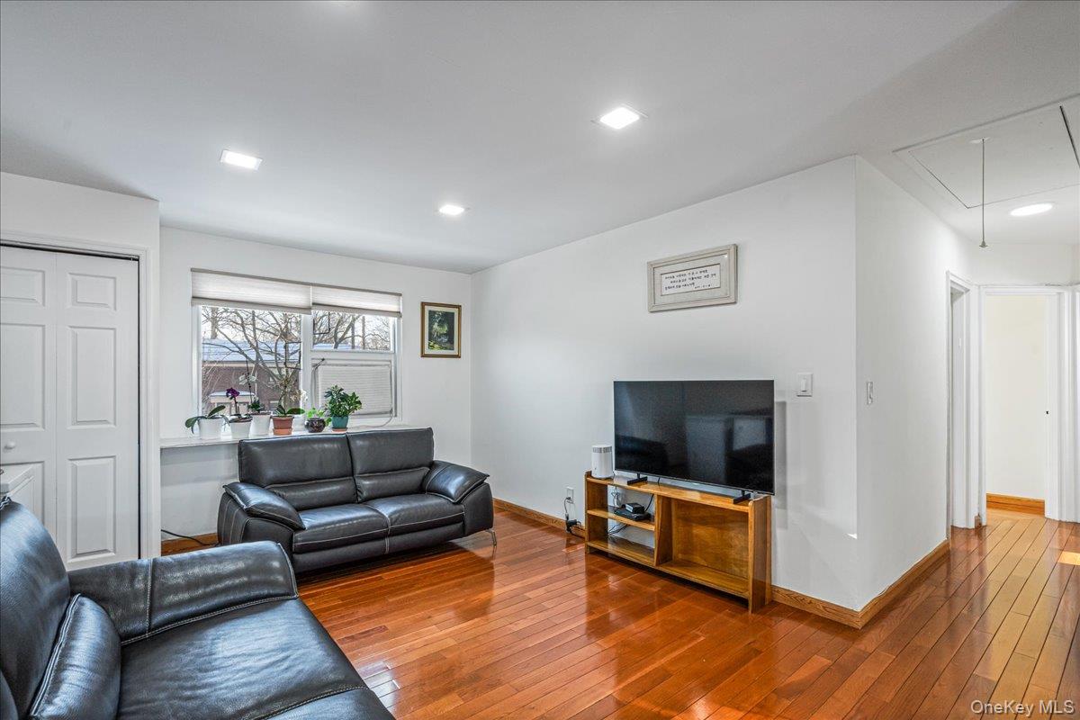 218-07 73rd Avenue, Unit UPPR Queens, NY 11364 - Photo 7 of 23 a living room with furniture and a flat screen tv