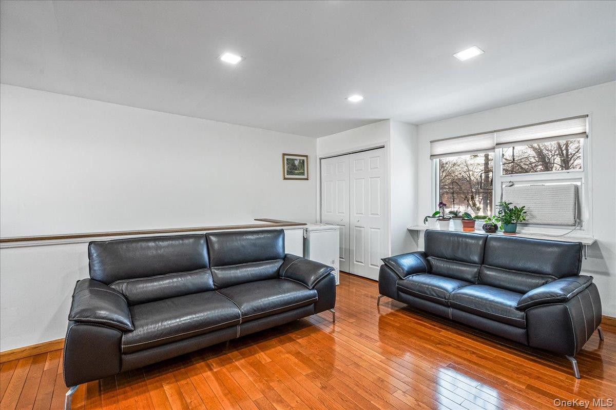 218-07 73rd Avenue, Unit UPPR Queens, NY 11364 - Photo 8 of 23 a living room with furniture and a couch