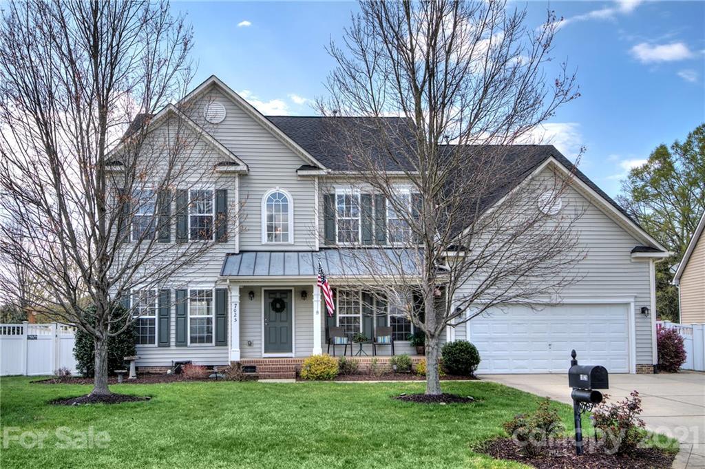 7025 Meyer Road Fort Mill, SC 29715 - Photo 1 of 41 a front view of a house with garden and trees