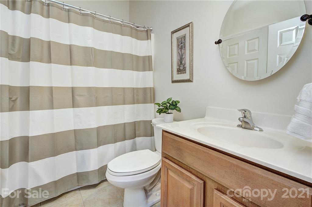 7025 Meyer Road Fort Mill, SC 29715 - Photo 17 of 41 a bathroom with a sink a toilet and shower