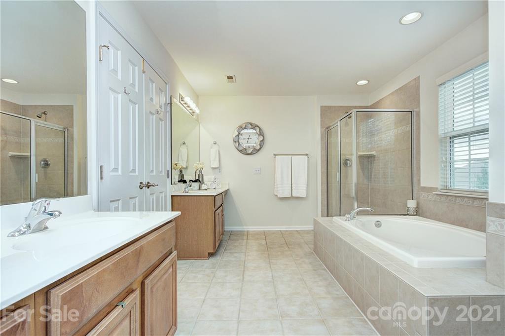7025 Meyer Road Fort Mill, SC 29715 - Photo 22 of 41 a spacious bathroom with a bathtub sink and mirror