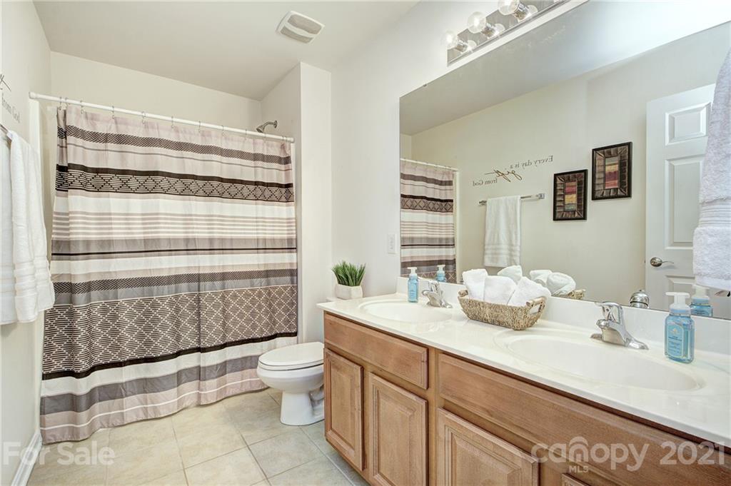 7025 Meyer Road Fort Mill, SC 29715 - Photo 24 of 41 a bathroom with a sink a toilet and shower curtain