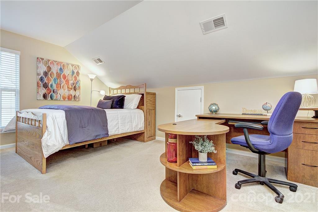 7025 Meyer Road Fort Mill, SC 29715 - Photo 25 of 41 a bedroom with a bed and a chair in it