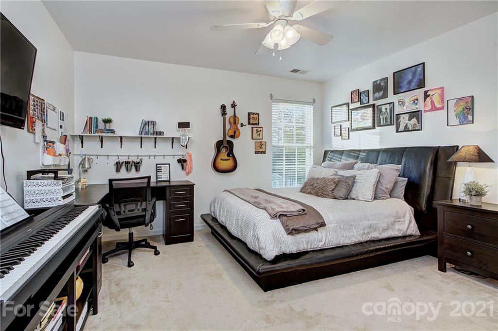 7025 Meyer Road Fort Mill, SC 29715 - Photo 27 of 41 a bedroom with a bed and a book shelf