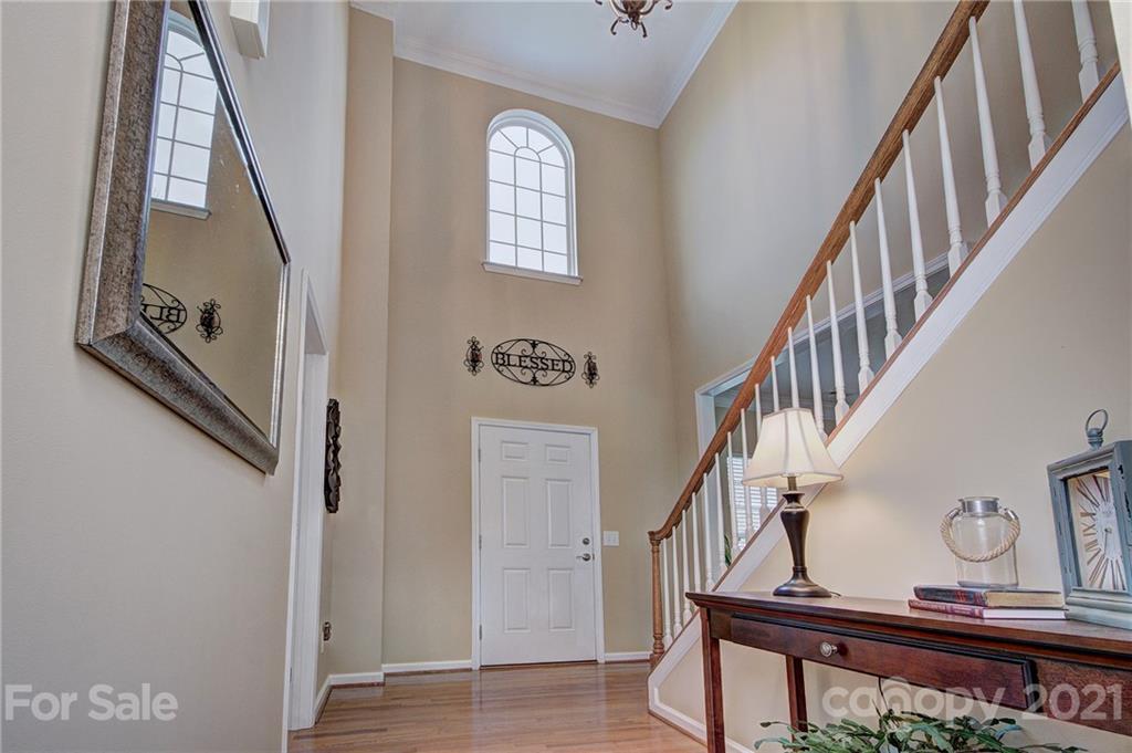 7025 Meyer Road Fort Mill, SC 29715 - Photo 5 of 41 a view of staircase with lots of frames on wall and a window