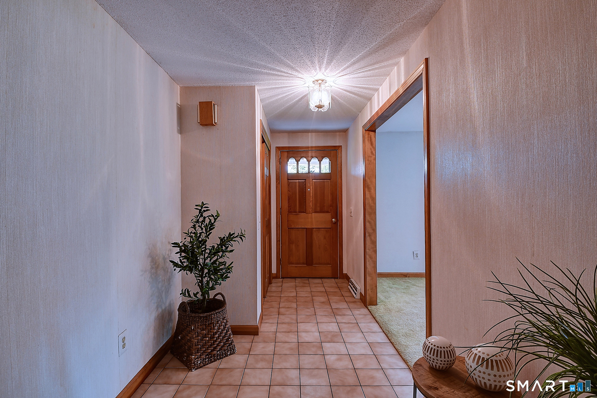 80 Grist Mill Road Wethersfield, CT 06109 - Photo 5 of 40 a view of a hallway with potted plants
