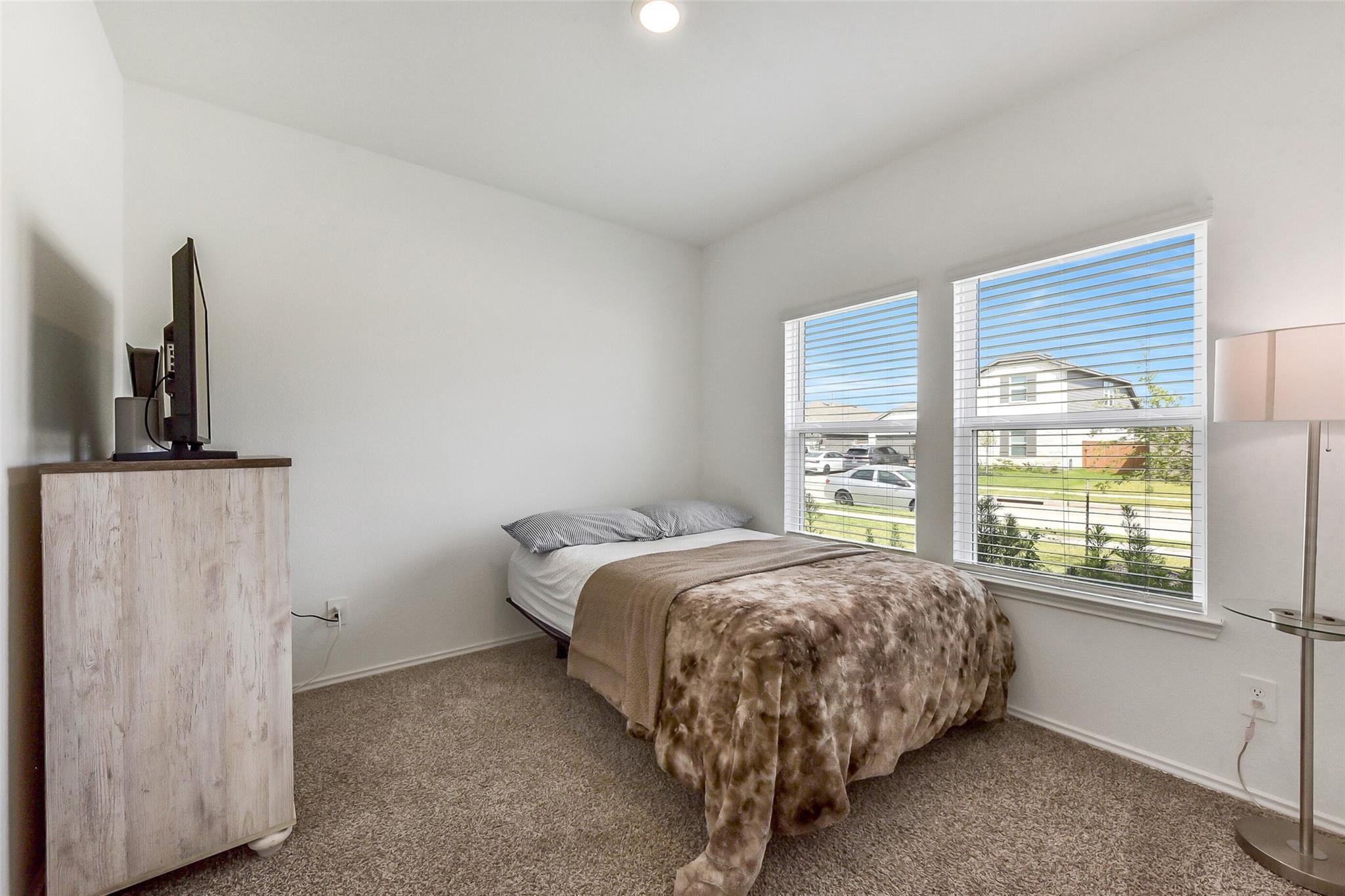 4985 Blue Beetle Rdg Drive Katy, TX 77493 - Photo 21 of 40 a bed sitting in a bedroom next to a window